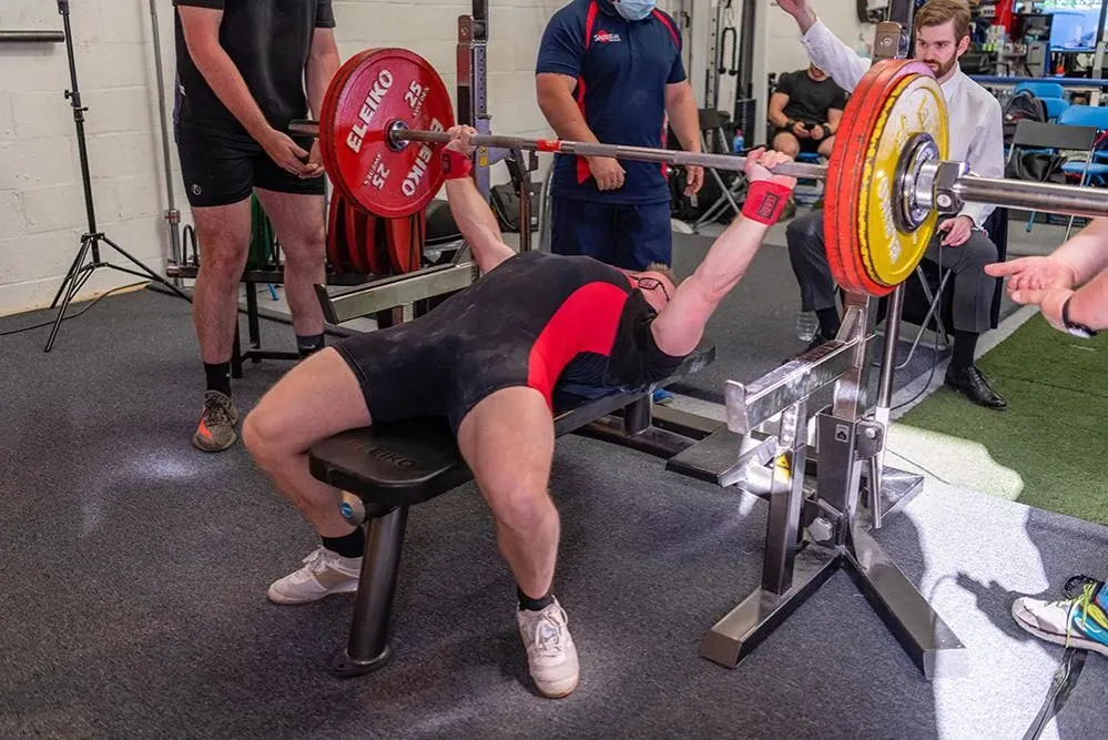 Andrew arched on the bench pressing 162.5 kg as a referee signals