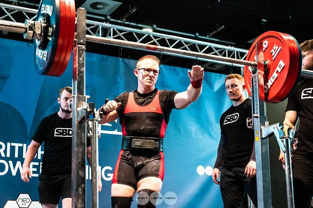 Andrew walking up to the rack for his final squat of 222.5 kg