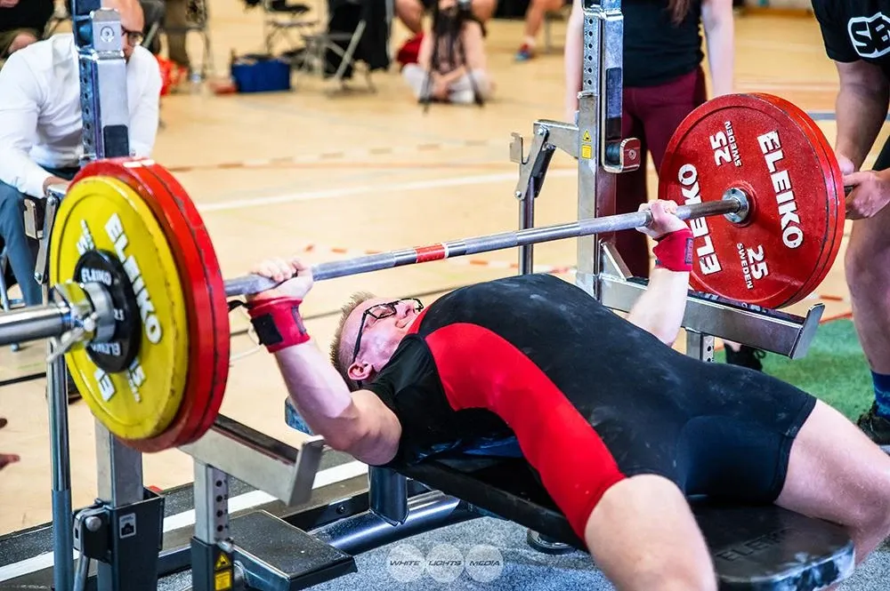 The 160 kg bar about to touch Andrew’s chest