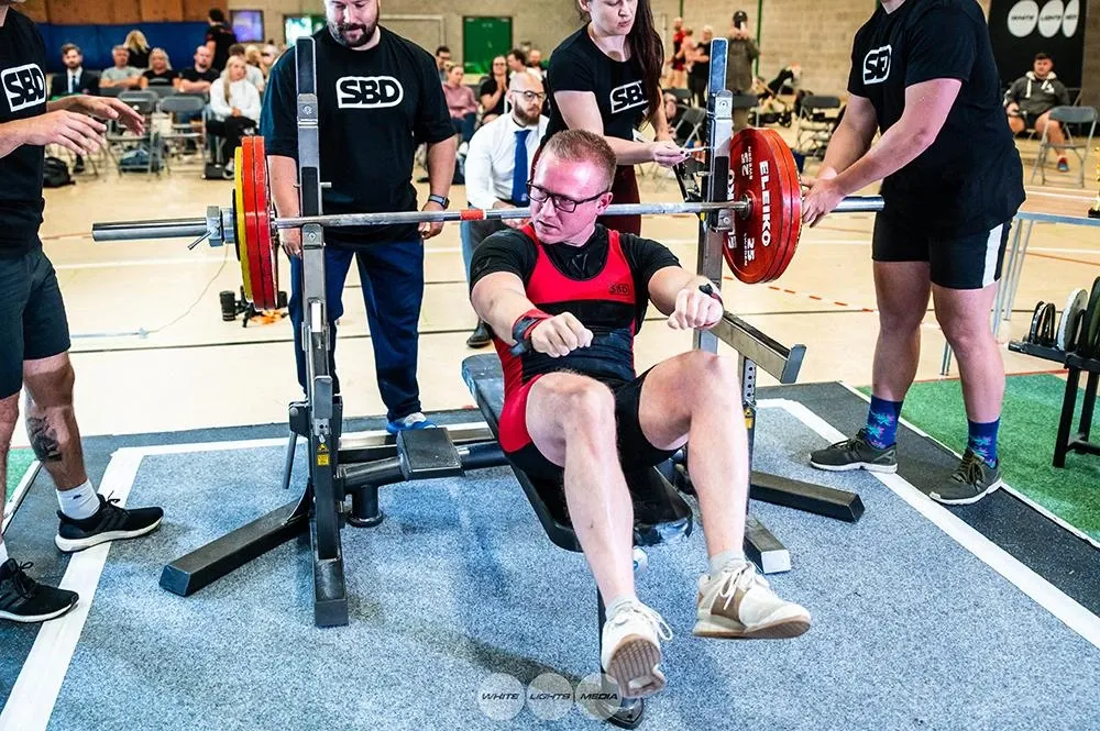 Andrew sitting up on the bench after racking 160 kg, waiting to see if he got the lift