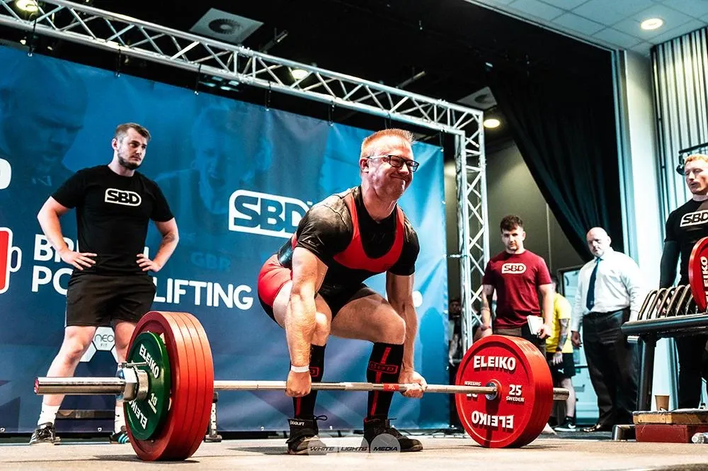 Andrew gripping the bar, about to deadlift 245 kg