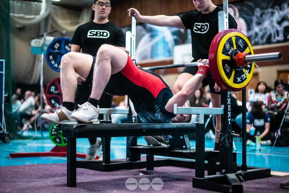 Andrew getting into position on the bench to lift 157.5 kg for the win