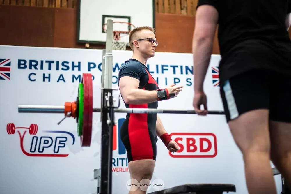Andrew on the platform explaining to the spotters how to hand him the bar
