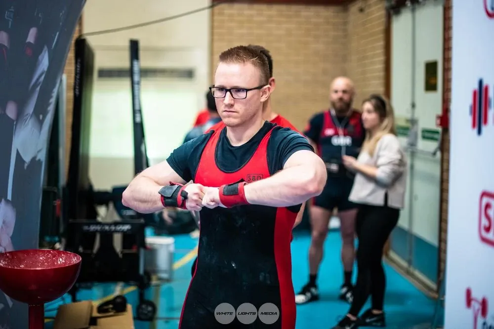 Andrew tightening his wrist wraps before an attempt