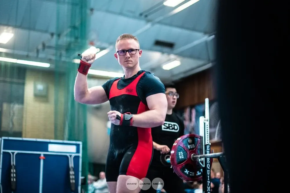 Andrew raising a fist to celebrate his good lift at 157.5 kg, which took gold