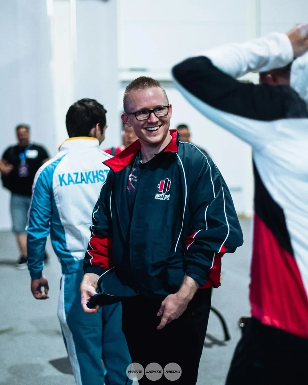 Andrew laughing in the oversized GBR team jacket