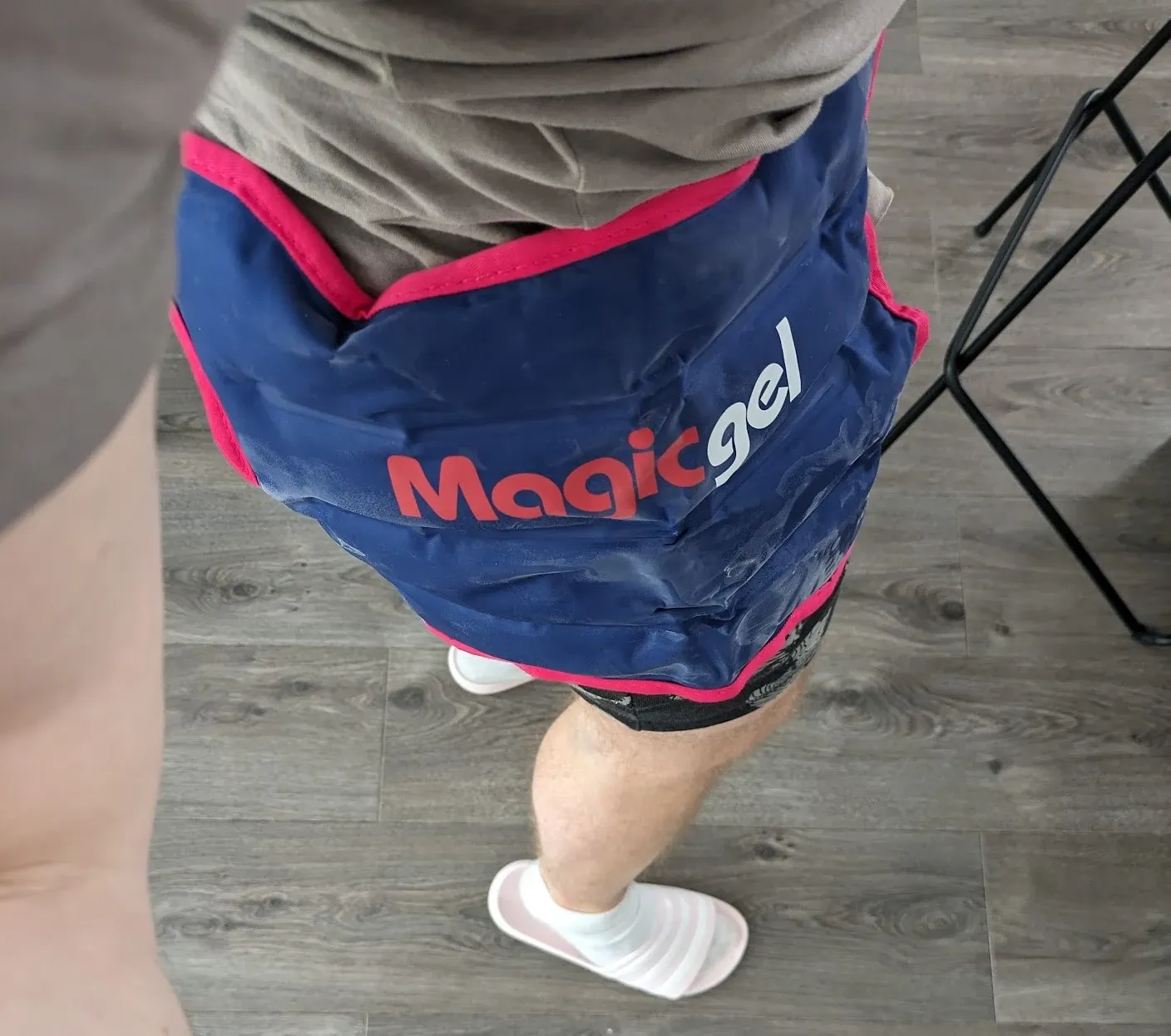 Looking down at a blue Magic Gel ice pack strapped around Andrew’s hip and upper thigh