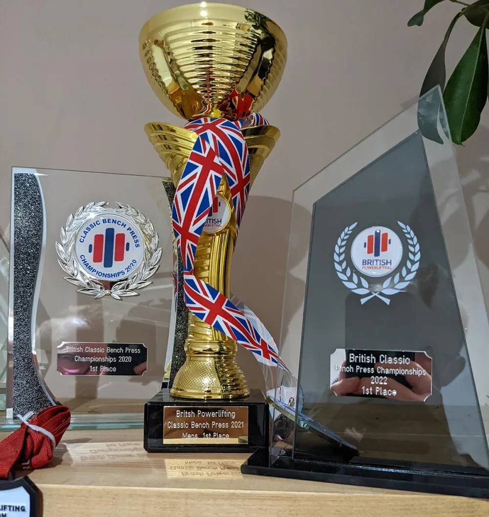 Three first-place trophies from the 2020, 2021 and 2022 British Classic Bench Press Championships
