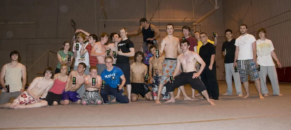 Trick Soc members in the gym hall holding up cans of Monster Energy