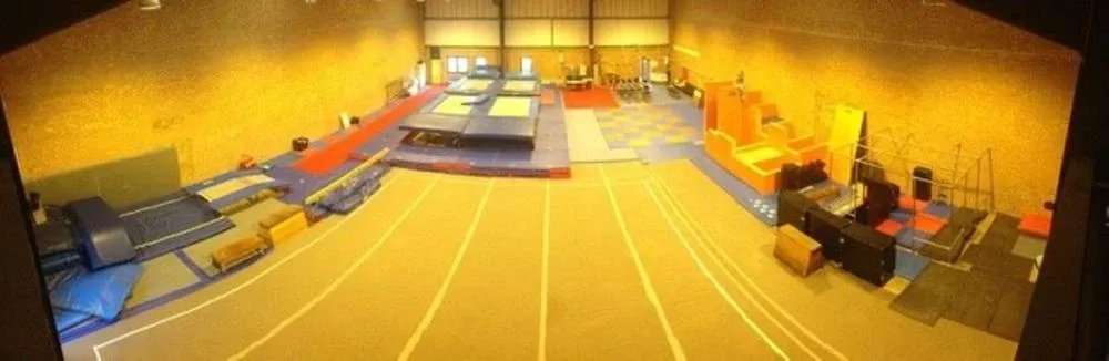 A panoramic view of the newer UrbanTrix Academy hall, with a sprung floor, trampolines, foam blocks and parkour bars