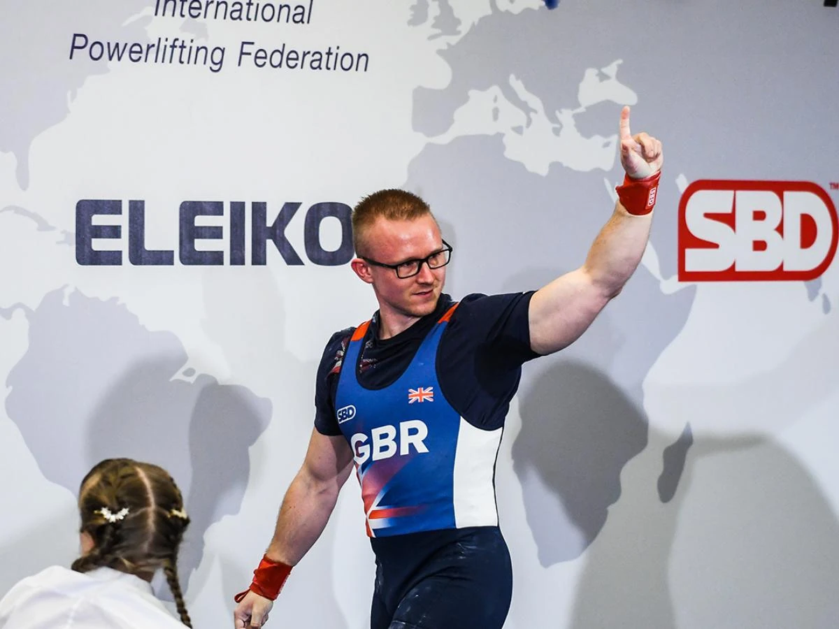 Andrew in the GBR singlet, one finger raised after a good lift at the 2021 IPF World Bench Press Championships