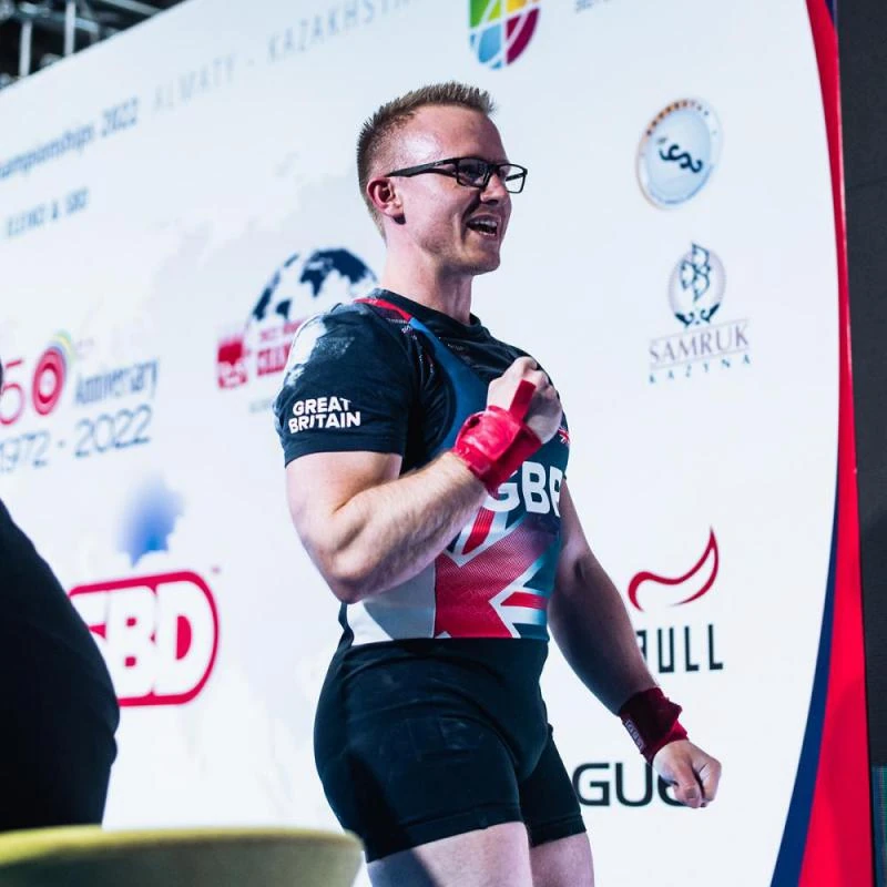 Andrew in the Great Britain singlet, fist raised after a good lift at the 2022 IPF World Bench Press Championships